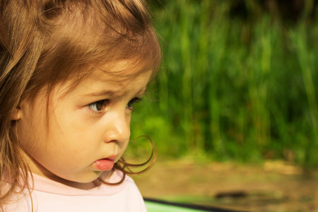 Portrait of a beautiful little girl in the forest