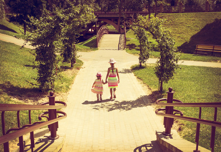 vintage portrait of Little girls in running on the park with sunsetの写真素材