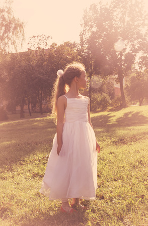 Cutel little girl wearing fairy costume enjoy summer at sunset. Tonedの写真素材