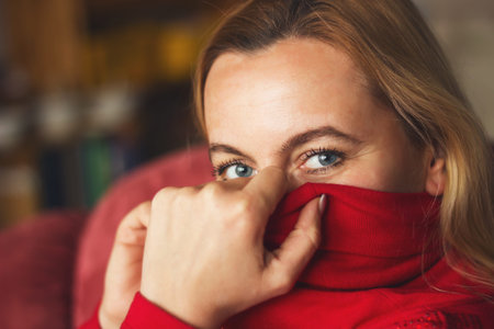 portrait of a beautiful woman in red dress with a sexy lookの写真素材