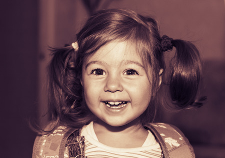 Toned portrait of happy pretty little girl smilingの写真素材