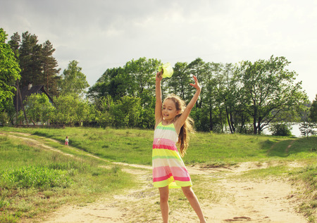 Cute little girl is playing before the rainの写真素材