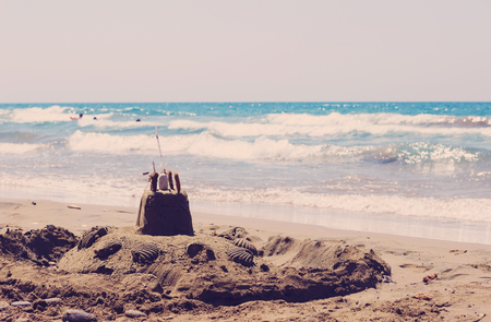 Holiday concept with sandcastle on the seaside. Tonedの写真素材