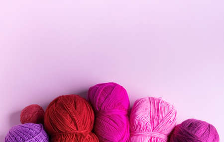 Pink red and purple knitted wool on a lilac background, hobbyの写真素材