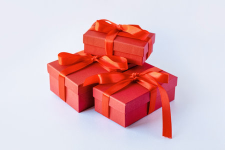 Red gift box on a light background, a gift for holidays, Christmas, birthdayの写真素材
