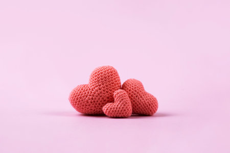 Croched pink hearts on a pink background. Valentines Day, symbol of love.の写真素材