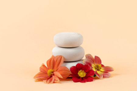 Wooden round podium pedestal cosmetic beauty product presentation empty mockup on orange pastel background with flowers dahliasの写真素材