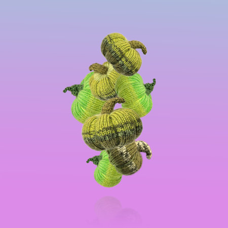 Flying knitted green pumpkins on purple background. Concept of autumn, Halloween, Thanksgiving. Diy Home Decorの写真素材