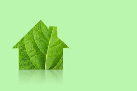 Mockup of the house is made of green leaf isolated on green background. Ecology concept. World Nature Conservation Dayの写真素材