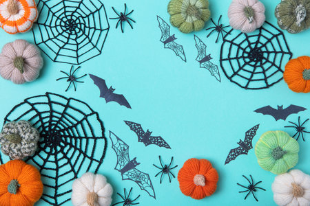 Halloween greeting card mockup with copy space. Halloween decorations, spiders, bats, knitted webs, pumpkins on green background. Happy Halloween holiday concept. Flat lay, top viewの写真素材