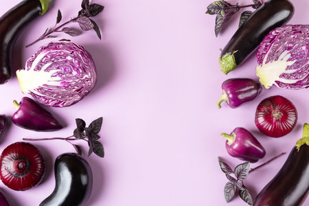Composition of fresh vegetables eggplants, cabbage, pepper, onion and basil leaves of on pastel lilac lavender background. Creative food concept. Flat lay, top view.の写真素材