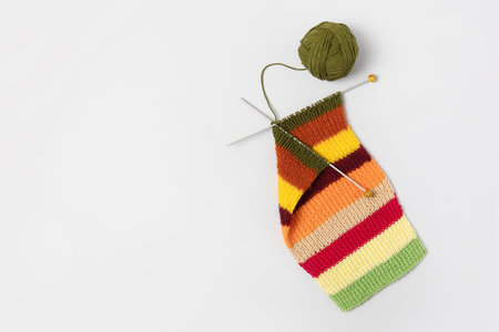 Bright autumn striped fabric or scarf made of yellow, green, orange. brown, burgundy and beige...