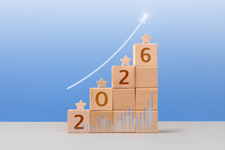 Wooden cubes with numbers 2026 and wooden stars are a symbol of success, business progress,...