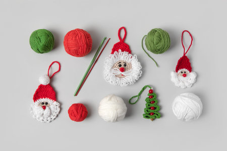 Crocheted toys Santa Claus in red hat, green Christmas tree with balls of thread and crochet hook on...