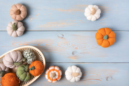 Cozy composition for needlework from basket with balls for knitting warm clothes and knitted pumpkin toys.の写真素材