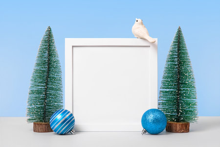 Christmas background with Christmas trees, turquoise ball, white birds and white frame for text,...
