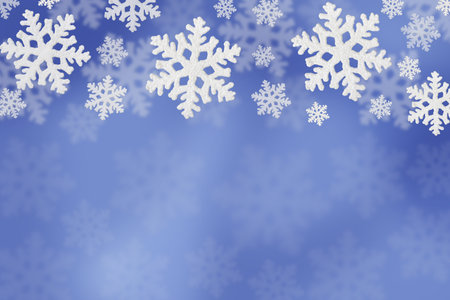 Christmas blue background of white snowflakes flying in the air. Holiday card for New Year and Christmas with space for greetings, labels and your design.の写真素材