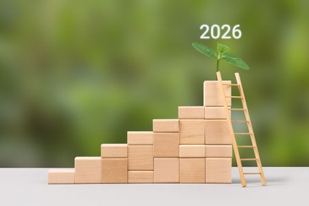 Business growth success achievement concept in 2026. Wooden blocks in form of graphical steps up and...