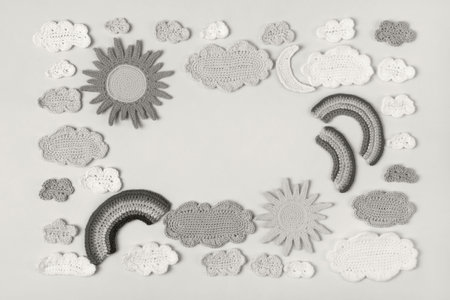Demonstrating the colors of 2026 - Cloud Dancer. Knitted toys clouds, sun, rainbow. Baby stuff and...