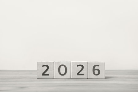 Demonstrating the colors of 2026 - Cloud Dancer. Postcard. Wooden cubes with numbers on a wooden...