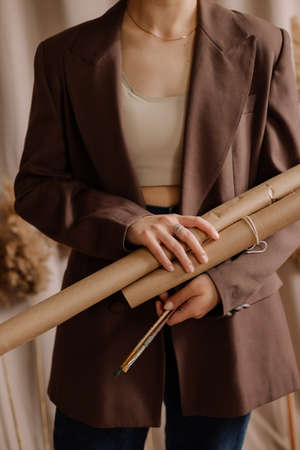 girl holding rolls of craft paper, scrollsの写真素材