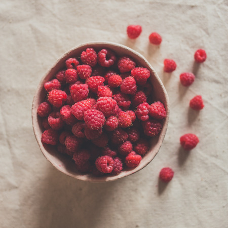 Crockery handmade, ceramic bowls, sweet raspberries, ceramic tableware, fragrant raspberry, sweet berriesの写真素材