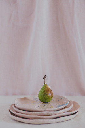 Juicy pear, set of ceramic plates, spotted utensils, ripe pears, crockery handmadeの写真素材
