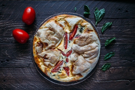 Cheese pie with tomato and basil.の写真素材