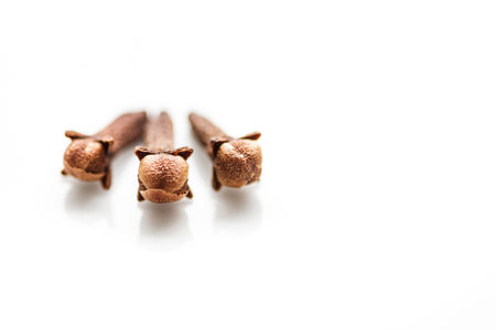 Three cloves on white background