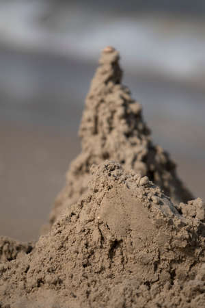 Blurred dark sand tower on the beachの写真素材