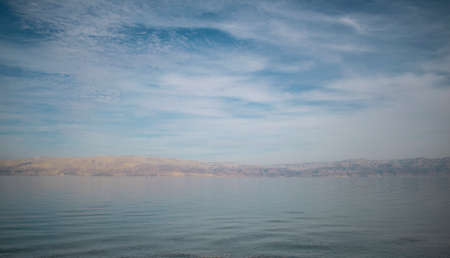 Dead sea blue sky landscape with sandy dunesの写真素材