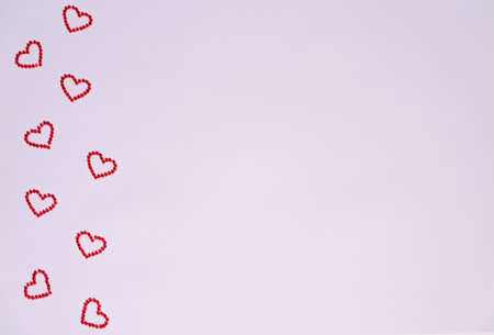 Wooden calendar show of February 14 and box of heart shaped chocolates. Red rose wrapped in ribbon. Lifestyle, copy space. St Valentines day concept.の写真素材