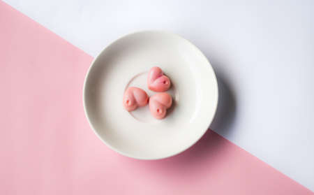 White pink composition with saucher and chocolatesの写真素材