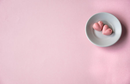 Gentle pink composition with saucher and chocolatesの写真素材