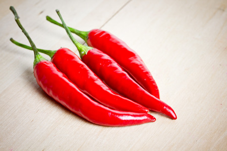 chili peppers on wooden backgroundの写真素材