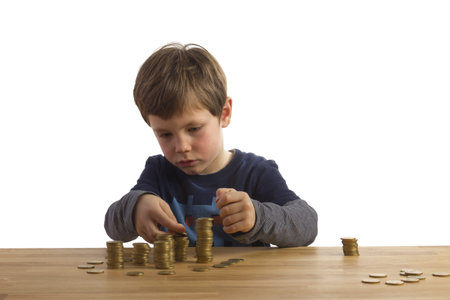 Boy building towers with 50 Euro Cent coinsの写真素材