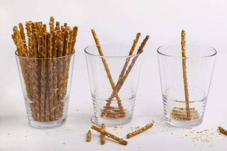 Three glasses of saltsticks, from full to only one leftの写真素材