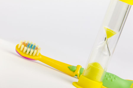 Toothbrush with sandglass on a white background