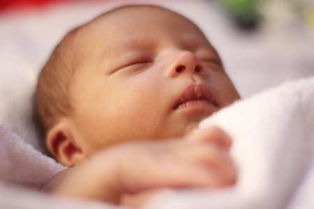Newborn baby sleeping on a white blanket. Shallow depth of fieldの写真素材
