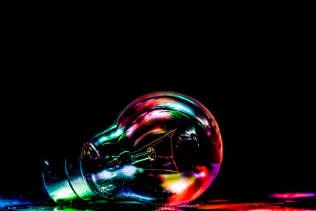 Colorful light bulb on black background with copy space for text.の写真素材
