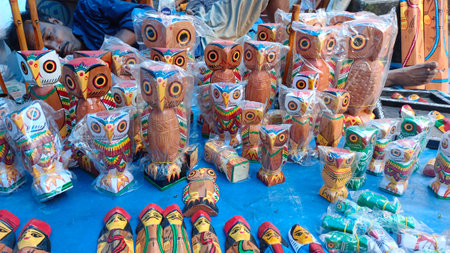 A captivating close-up shot of hand-painted cups, mugs, clay pots, wooden stools, tables, and chairs, all meticulously crafted by artisans from the villages of India. The image captures the vibrant colors and intricate patterns of each item, showcasing the rich cultural heritage and creativity of rural India. These unique, handmade objects, including decorative pottery and Rajasthani crafts, reflect the essence of traditional artistry. Set against a rustic market backdrop, the colorful display offers a glimpse into India's rich craftsmanship, making it an ideal souvenir for those seeking a piece of authentic culture and design.の写真素材