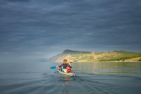 A man in a sea kayak on Lake Baikalの写真素材