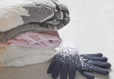 Knitting clothes on light backgroundの写真素材