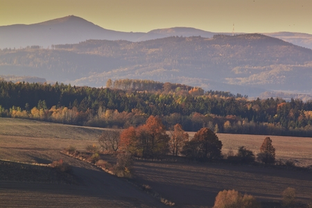 Hills and forest at autumn sunriseの写真素材