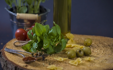 tomatoes, basil and spices on dark grunge backdropの写真素材