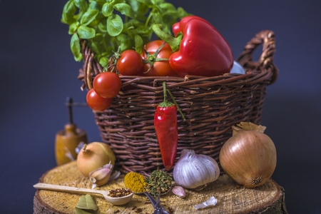 tomatoes, basil and spices on dark grunge backdropの写真素材