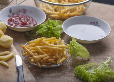 Fresh fried french fries with ketchup on wooden backgroundの写真素材