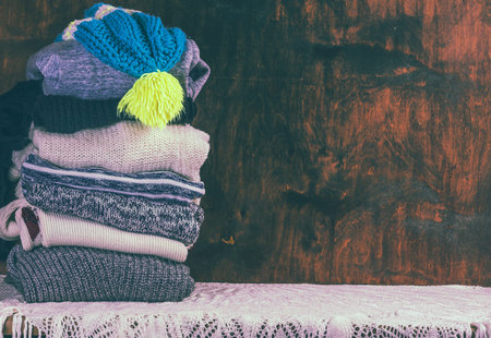 Knitting clothes on wooden background