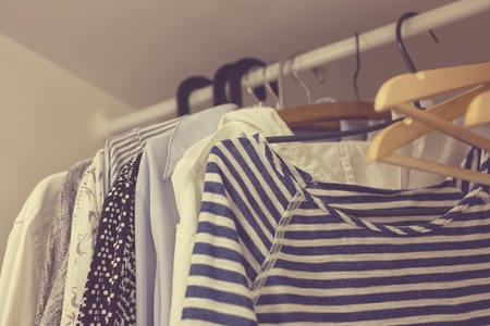 lclothes in the closet on a hangeの写真素材