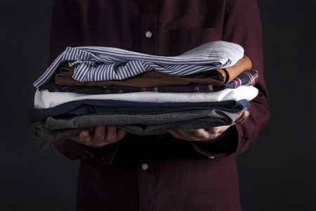 Man holding clothesの写真素材